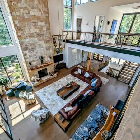 a living room with a large brick wall and a large balcony