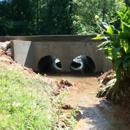 a concrete bridge over a stream