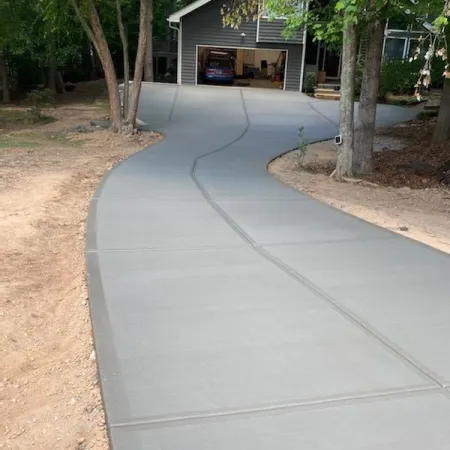 a sidewalk with trees and a building