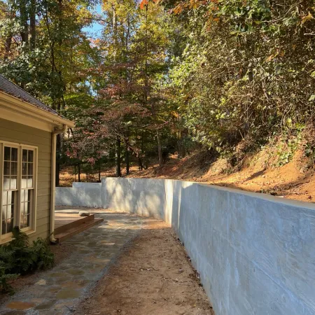 a concrete wall with trees around it