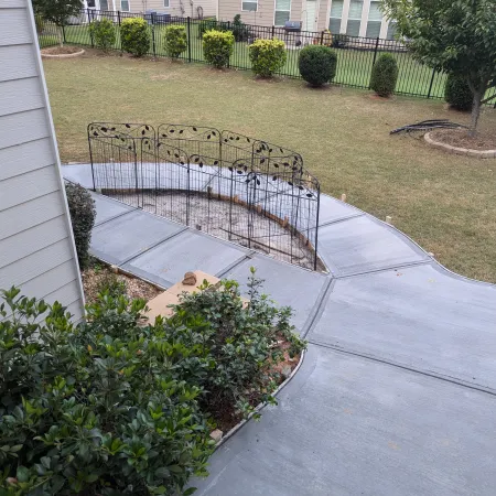 a backyard with a fence and a yard with a small garden