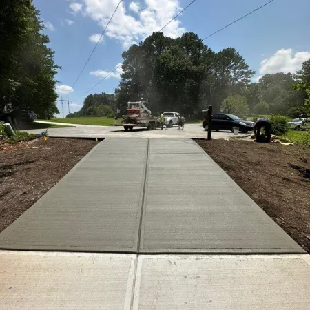 a road with a cement block and a person standing on the side