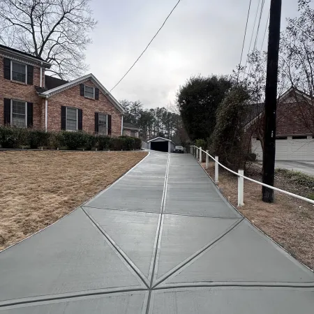 a road with a white fence and a white building on the side