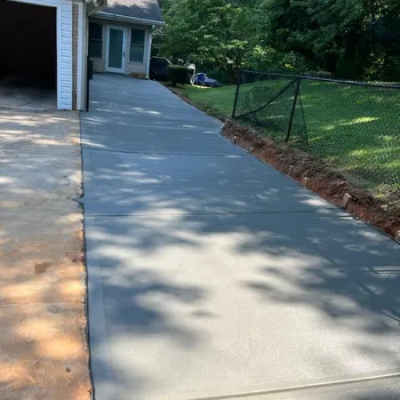 Concrete driveway extension leading to the back of the house