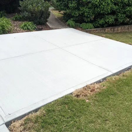 New concrete landing providing smooth access from driveway to backyard pathway