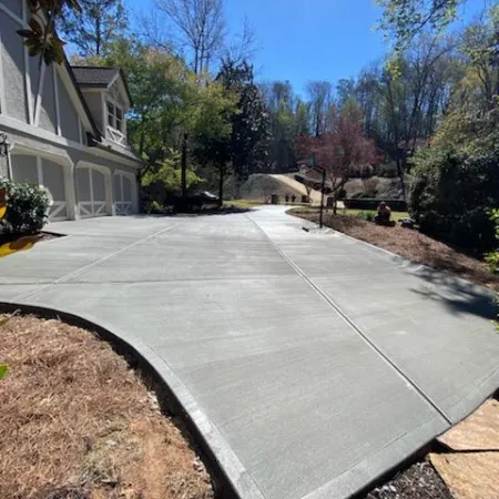 a driveway with a house and trees