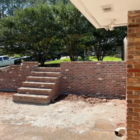 a brick wall with a brick walkway