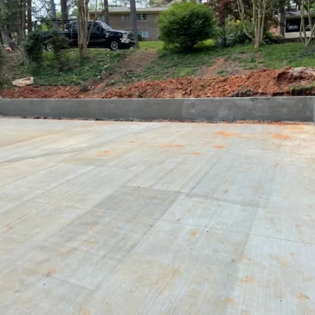 a concrete surface with a car parked in the background