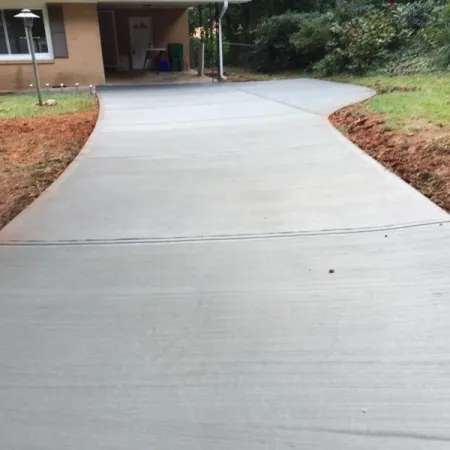 a paved walkway with a person walking on it