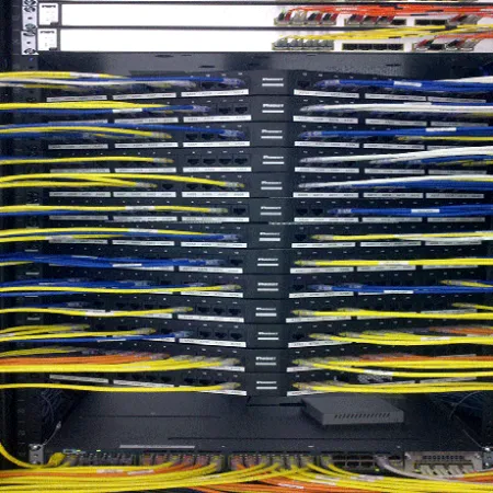Network server rack with colorful fiber optic cables neatly connected and organized for data transmission.