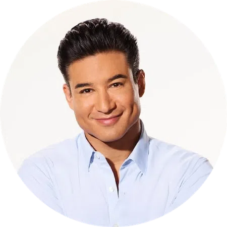 Smiling man with dark hair wearing a light blue button-up shirt against a white background