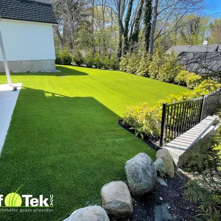 a backyard with a bench and a house