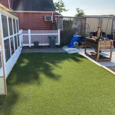 a backyard with a fence and a house
