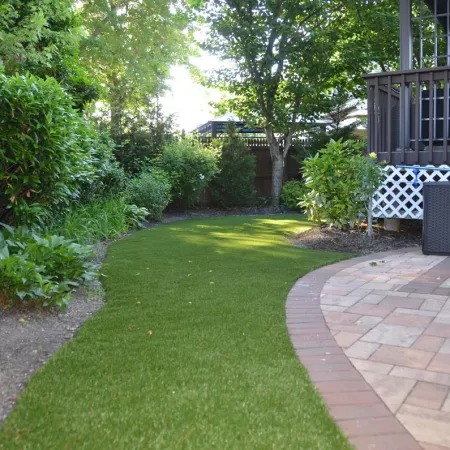 a brick walkway in a backyard