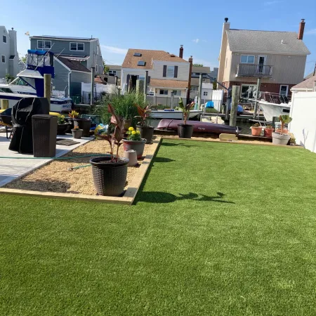 a grassy area with buildings in the background