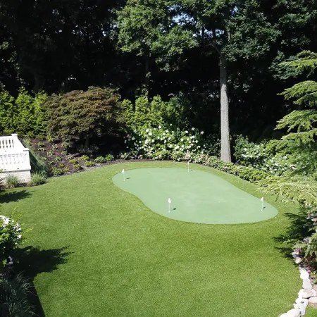 a large green lawn with a pond