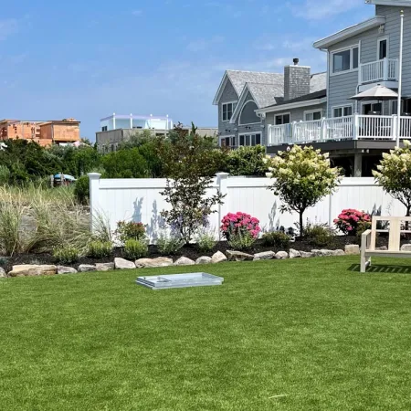 a bench in a grassy area with buildings in the background