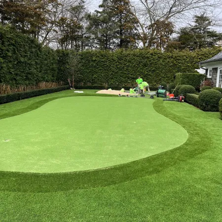 a large green lawn with a few people on it