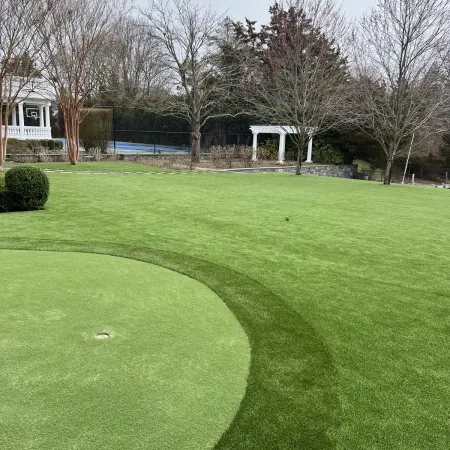 a large grassy area with trees in the background
