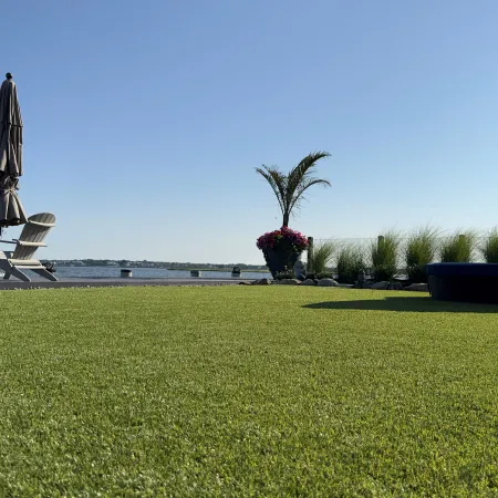 a couple of chairs and a table on a grassy field