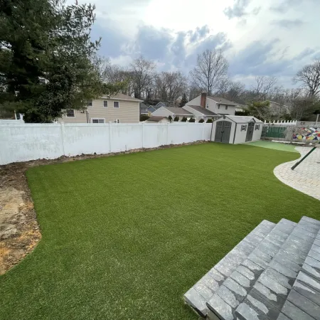 a backyard with a fence and a white fence