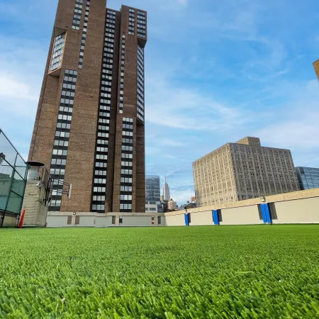 a tall building with a green lawn