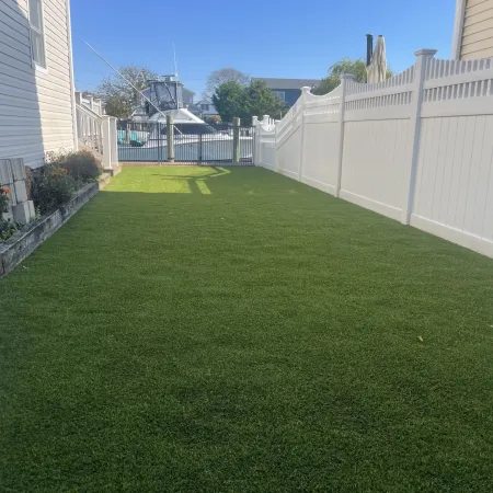 a yard with a fence and a building