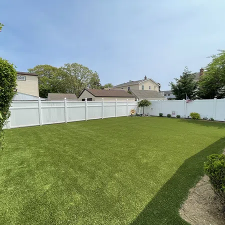 a fenced yard with a white fence and a white picket fence