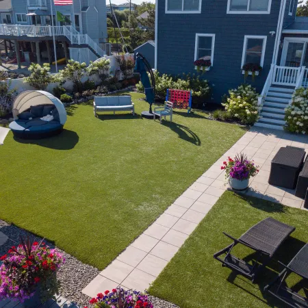 a backyard with a pool and chairs