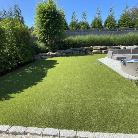 a large green lawn with a fountain