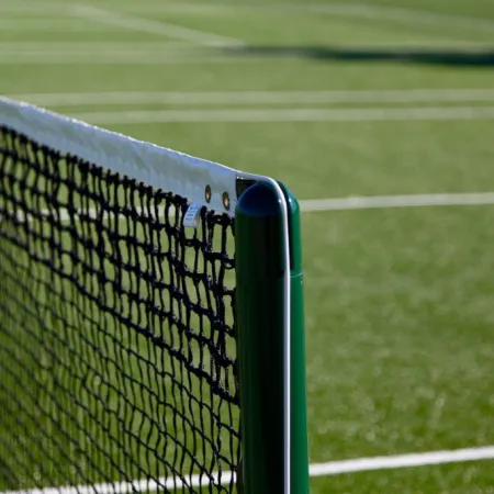 a green fence with a metal gate