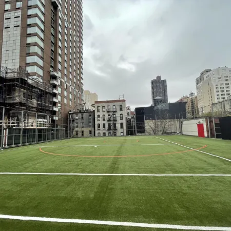 a football field with buildings in the background