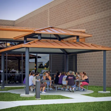 a group of people sitting at a table outside a building