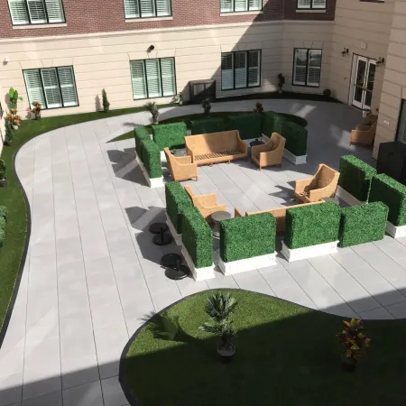 a courtyard with a pool and chairs