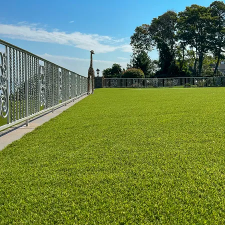 a fenced in area with a white wall and a white fence
