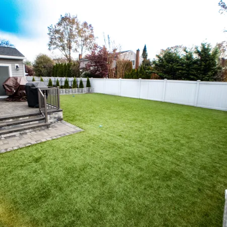 a backyard with a white fence