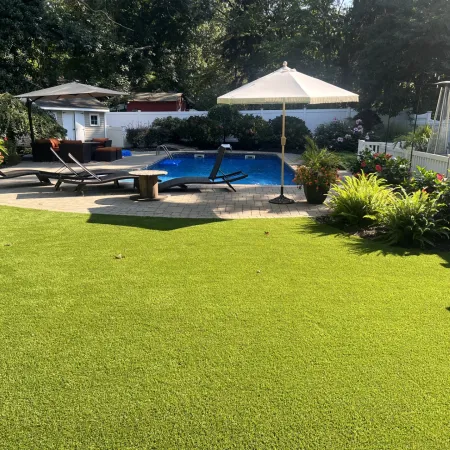 a backyard with a pool and umbrella