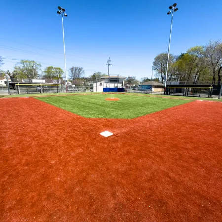 a field with a red dirt field