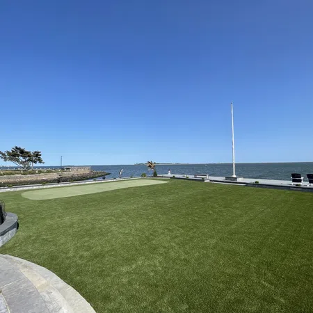 a golf course next to a body of water