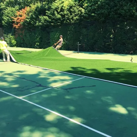 a group of people playing tennis