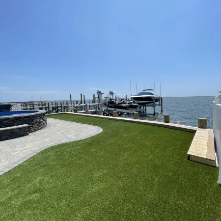 a grassy area next to a body of water