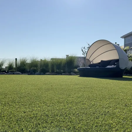 a large grass field with a building in the background