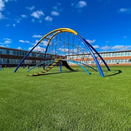 a large blue and white sculpture in a grassy field