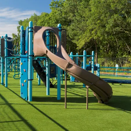 a playground with blue and green slide