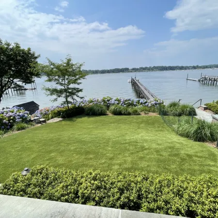 a grassy area with a body of water in the background