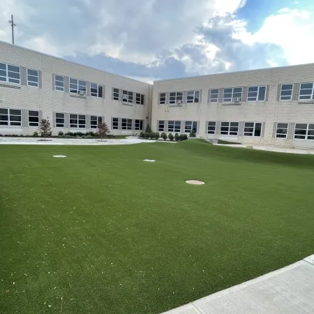 a building with a green lawn