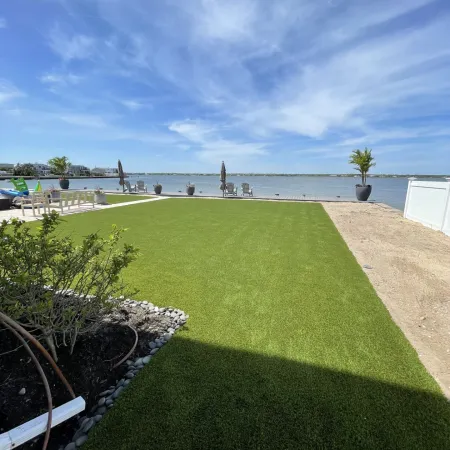 a grassy area with a body of water in the background