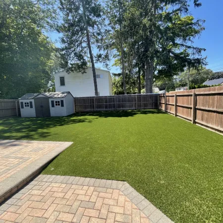 a backyard with a brick walkway