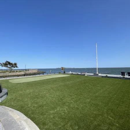 a golf course next to a body of water