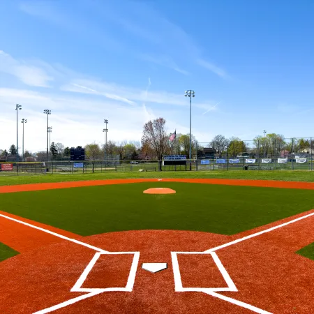 a baseball field with a red and white track